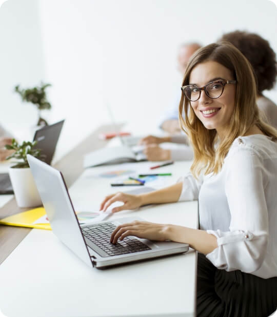 Girl with glasses doing digital marketing work on laptop